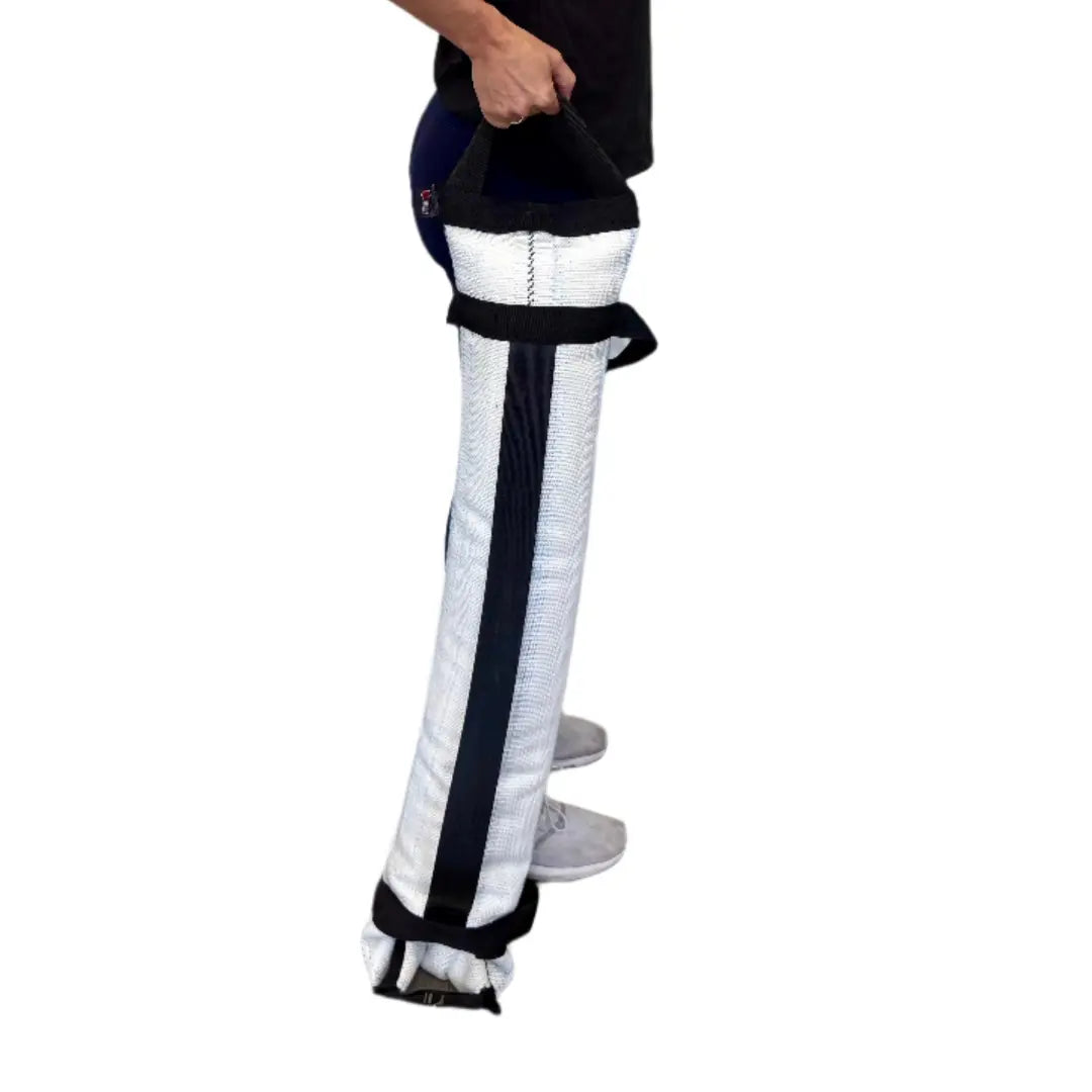 Person holding a white and black workout battle bag made of recycled fire hose.