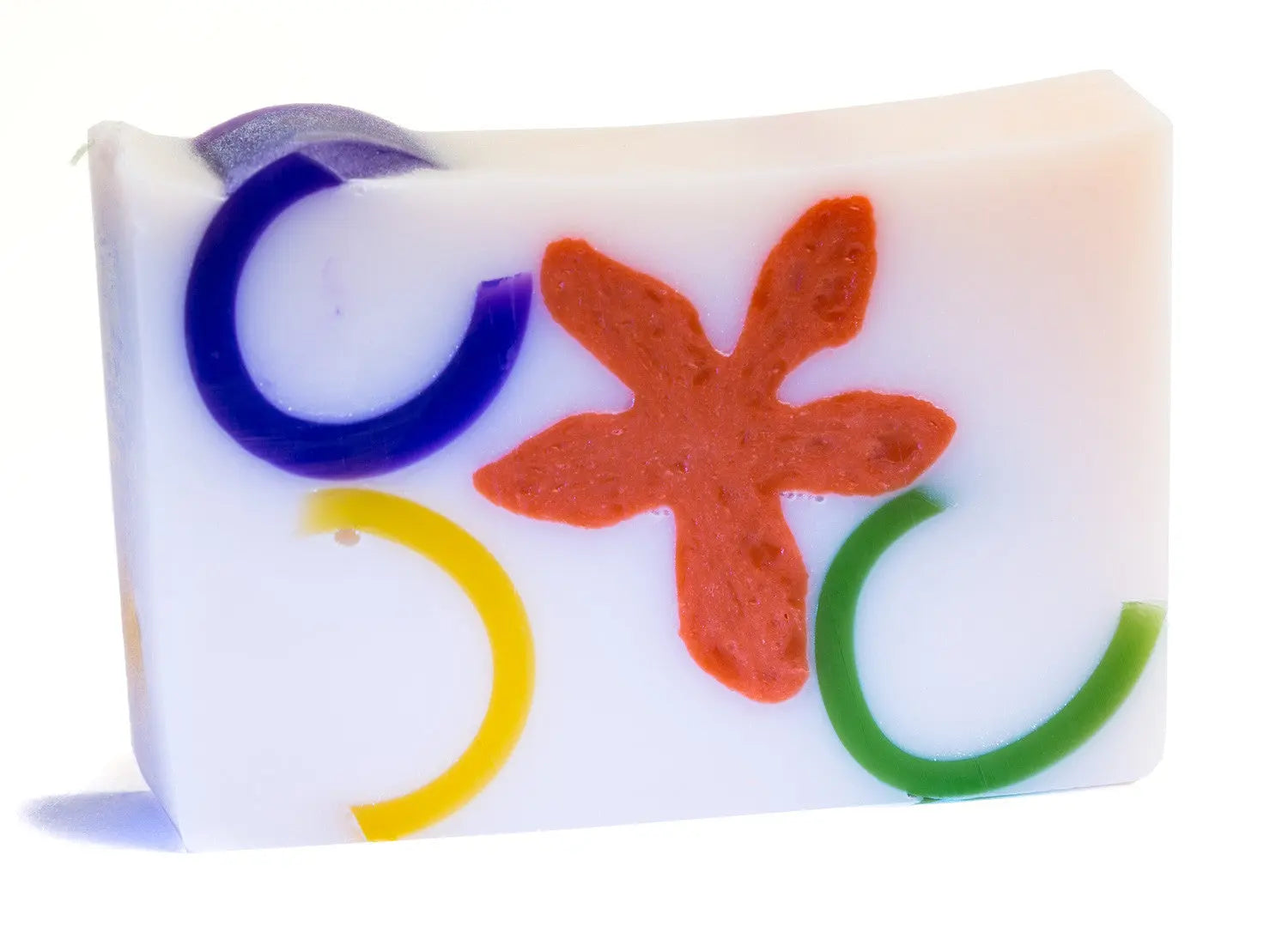 White soap slice with colorful rings and a red flower shape inside.