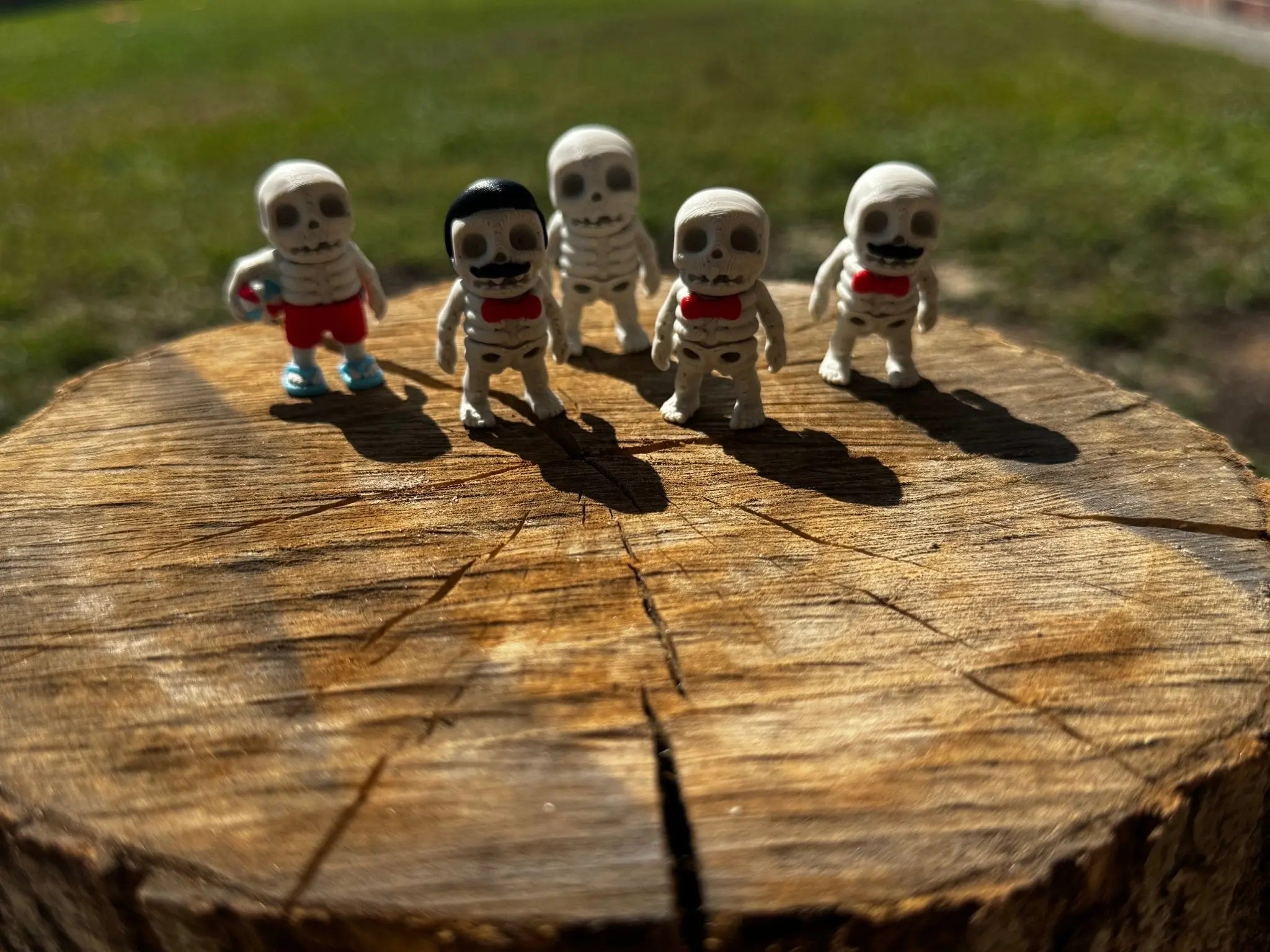 Zombie Skeleton Fidget Toy Wholesale Bundle by Main Street Collective: Five creepy toys on a tree stump.