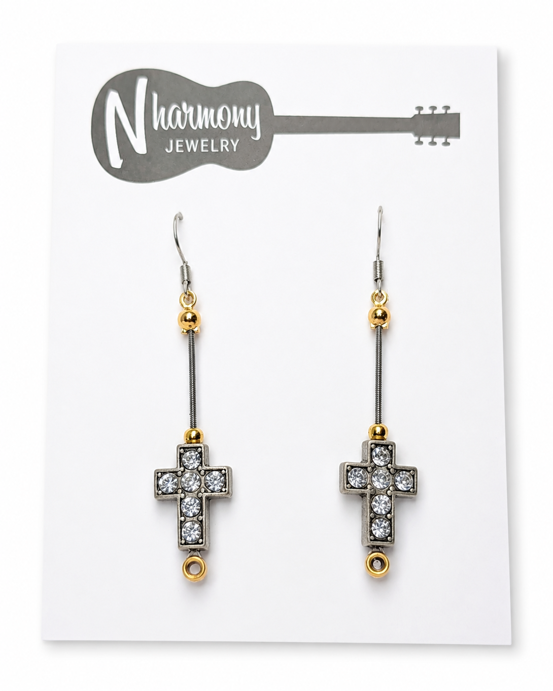 Cross-shaped earrings with rhinestones on a NHarmony Jewelry card.