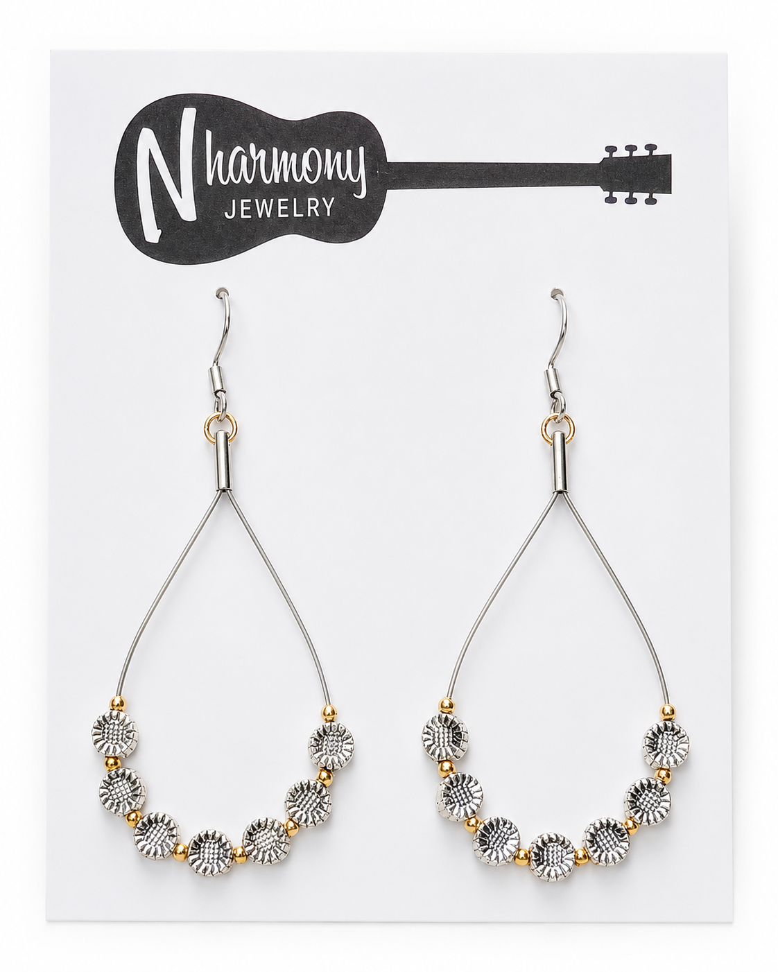 Pair of earrings on a N'Harmony Jewelry card with a guitar illustration.