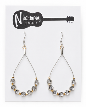 Pair of earrings on a N'Harmony Jewelry card with a guitar illustration.