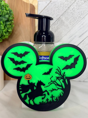 Green and black Halloween soap dispenser holder with bats and horseman scene