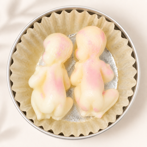 Little Baby Lotion Bars in an open tin with soft cream and pink marbled solid lotion bars