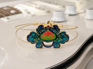Decorative bracelet with floral design on a guitar