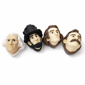 Four 3D printed president clicker heads arranged on a plain white background