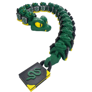 Professor Snake articulated 3D printed serpent with green shield segments, yellow eyes, fangs, and a book-shaped tail