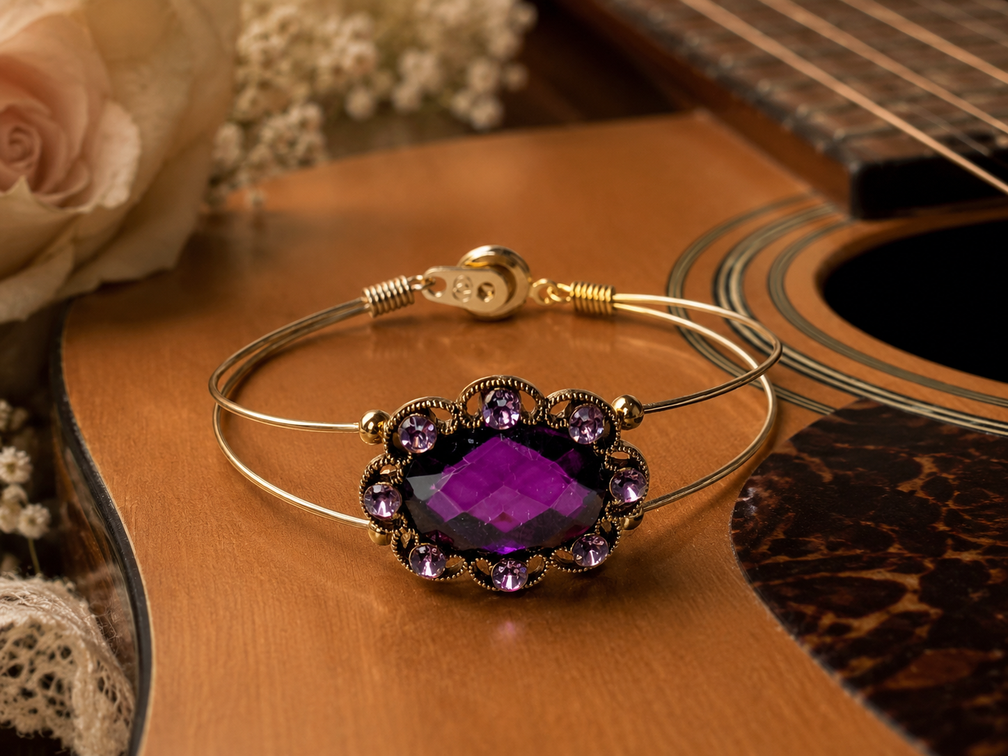 Bracelet with purple gemstone on a guitar