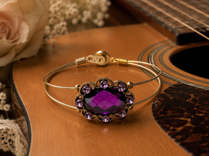 Bracelet with purple gemstone on a guitar