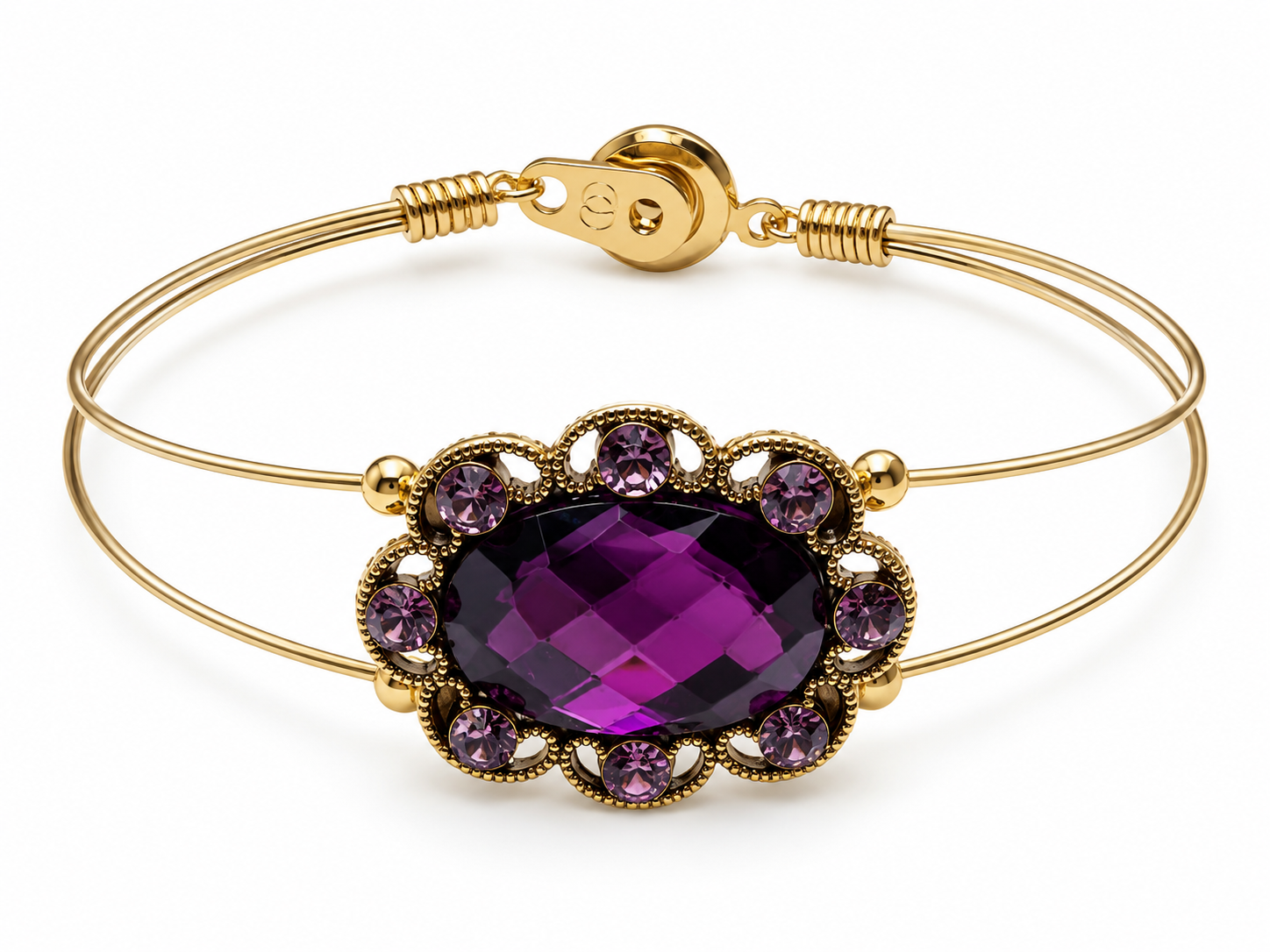 Gold bracelet with a purple gemstone on a white background