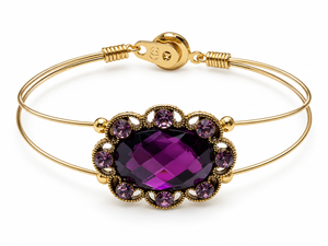 Gold bracelet with a purple gemstone on a white background
