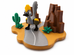 3D printed desert bird playset with green cactus, rocky cliffs, and gray road base