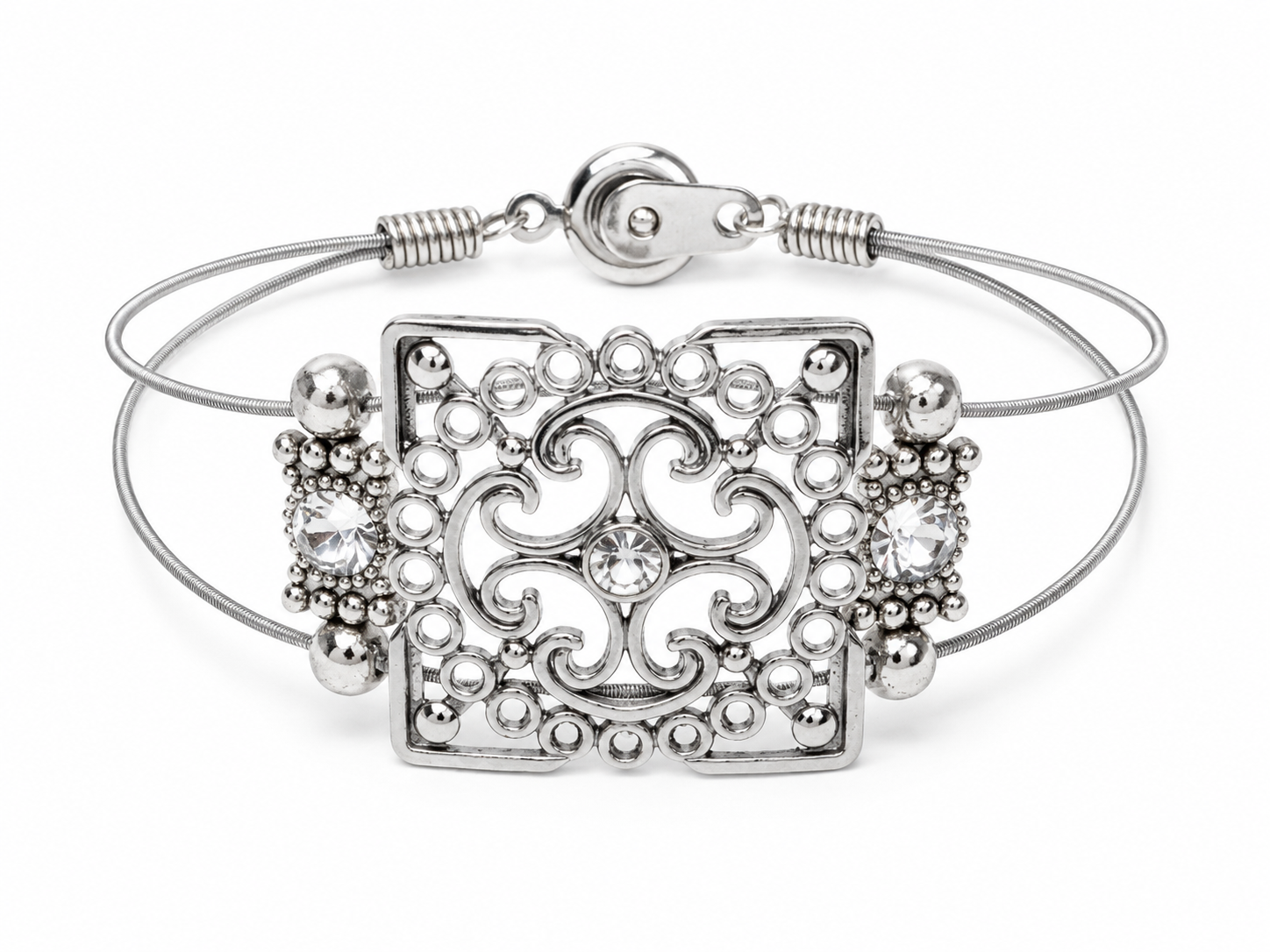 Silver bracelet with intricate design on a white background