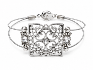 Silver bracelet with intricate design on a white background