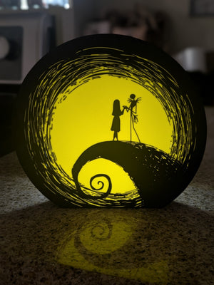 Spiral hill couple Halloween LED table lamp glowing yellow from the front