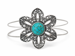 Floral bracelet with turquoise center and silver accents on a white background