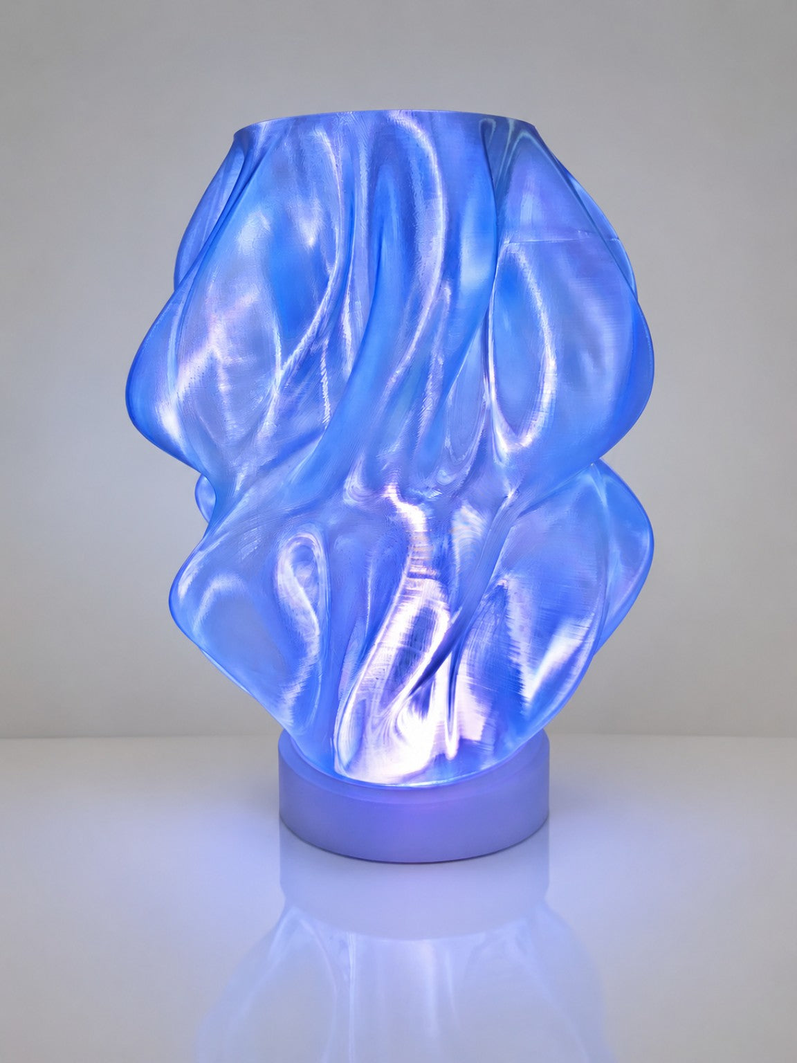 Blue transparent PLA 3D printed lamp with LED light by The Tween Space on a clean background