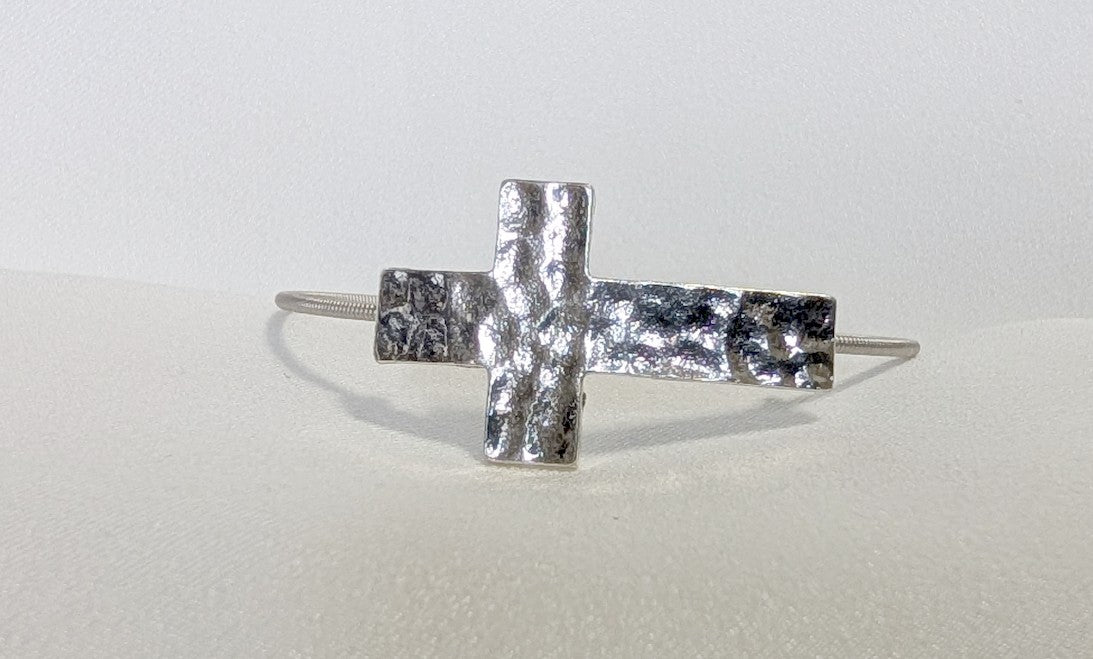 Silver colored hammered cross bracelet