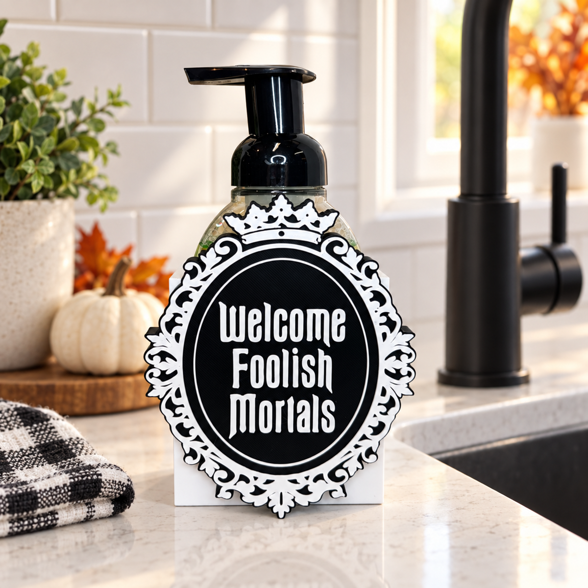 Welcome Foolish Mortals Halloween soap dispenser beside a kitchen sink